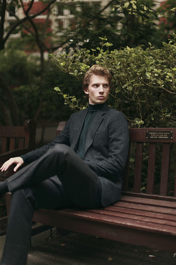 Young Male model standing in a bench